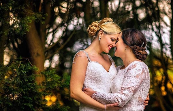 Two brides hugging